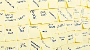A picture of post it notes featuring words to avoid in business communication, including business jargon.