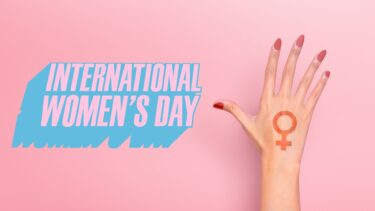A hand with a pink background and the message 'internation women's day.'